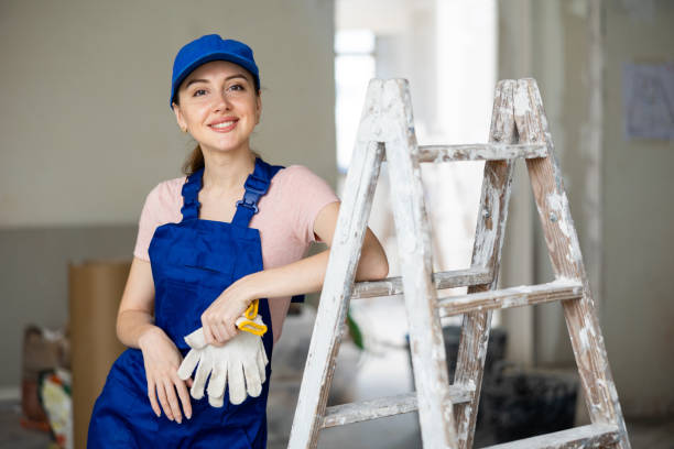 istock Female worker posing in apartment being renovated 1406870964
