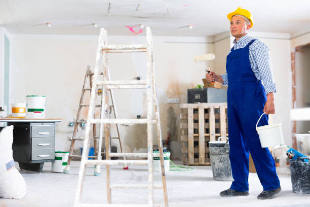 istock Man painter working in apartment, carrying bucket and roller 1406871241