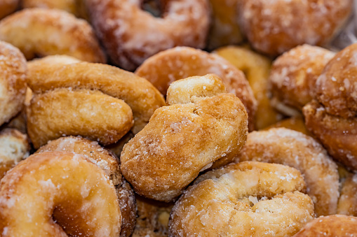 Homemade aniseed doughnut with sugar traditional in the gastronomy of Spain, usually eaten at Easter, selective focus on the center of the image.