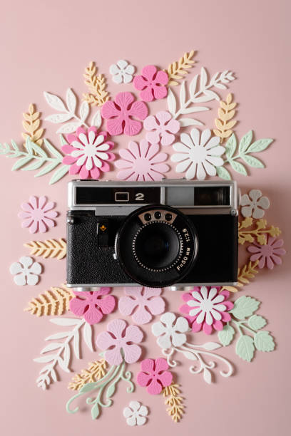 istock The retro camera is decorated with flowers and leaves. 1406873775