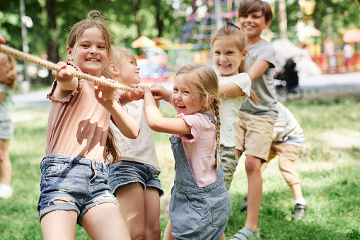 Group of kids playing tug of war