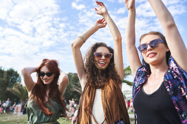 istock Three friends dancing together on summer festival 1406876147