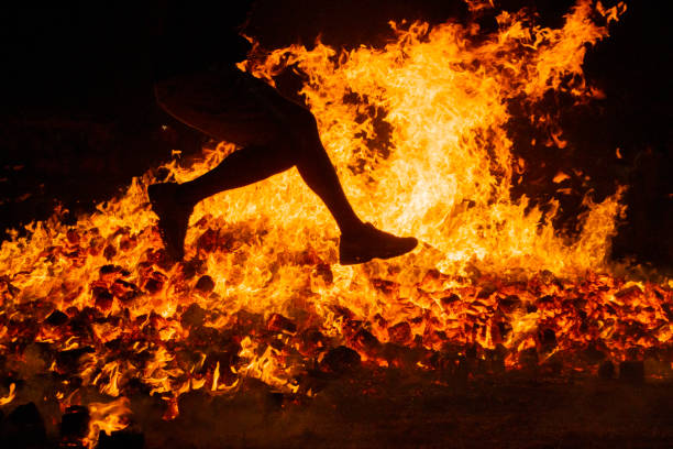 istock Summer solstice celebration jumping into the fire. Burning flames 1406876446