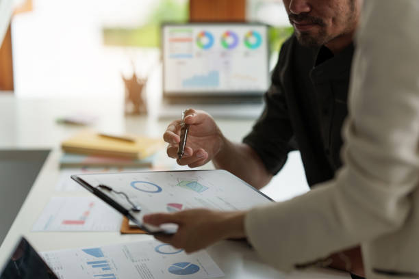 istock Analytics intelligence concept. Group of business people discuss current financial and economic on laptop for investment at the meeting. 1406876583