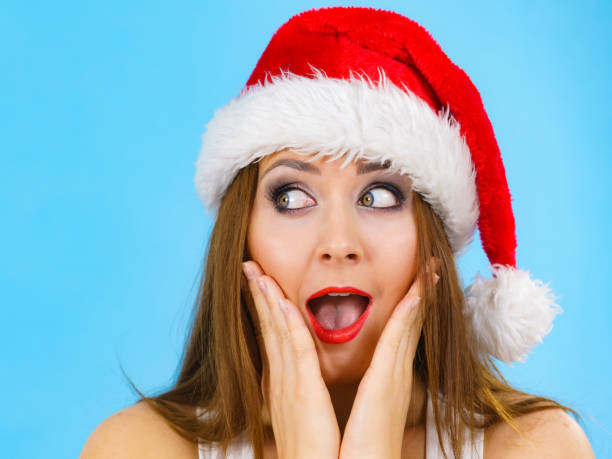 istock Surprised woman in santa claus hat 1406879056