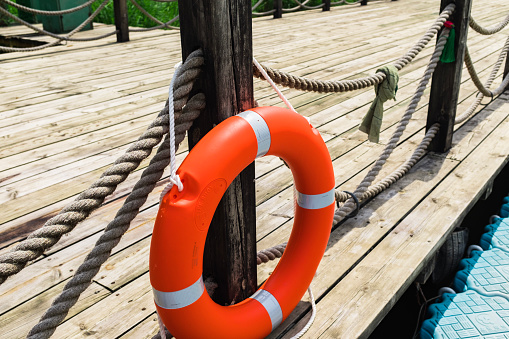 Lifebuoy hanging on the pier railing