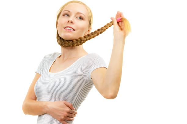 Young man looking at camera with pretty blond intentionally blurred in background