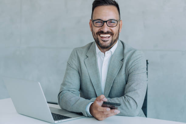 istock Businessman texting on cellphone in the office. 1406880362