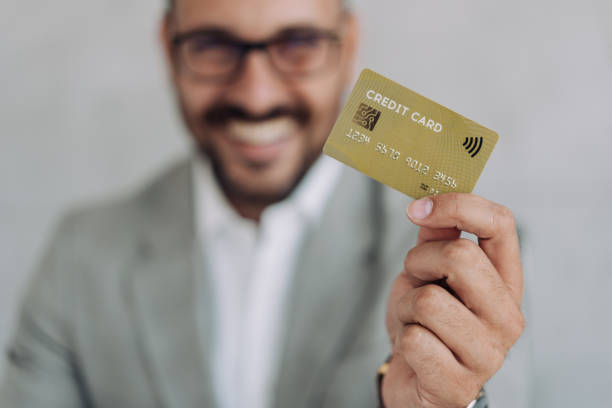 istock Man holding a credit card. 1406880390