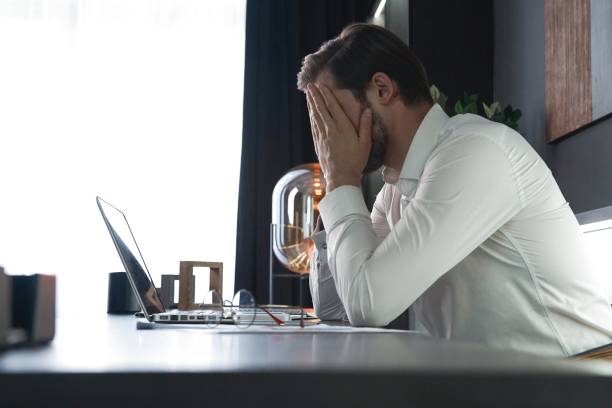 istock Frustrated stressed businessman feel tired having migraine during working. Exhausted man having headache and problem 1406880545