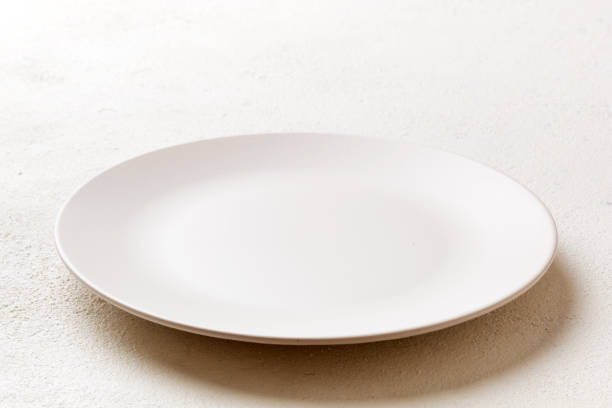 istock Perspective view of empty light plate on cement background. Empty space for your design 1406881125
