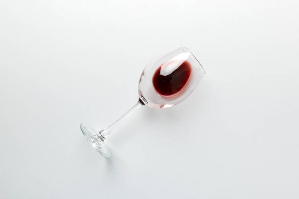 One glasses of red wine at wine tasting. Concept of red wine on colored background. Top view, flat lay design One glasses of red wine at wine tasting. Concept of red wine on colored background. Top view, flat lay design. merlot grape photos stock pictures, royalty-free photos & images