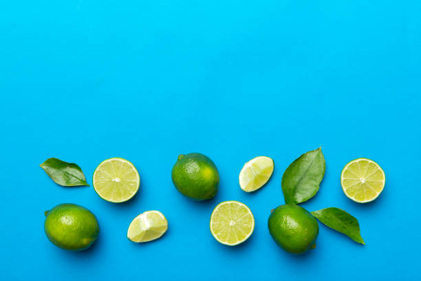 istock Lime fruits with green leaf and cut in half slice isolated on white background. Top view. Flat lay with copy space 1406881201