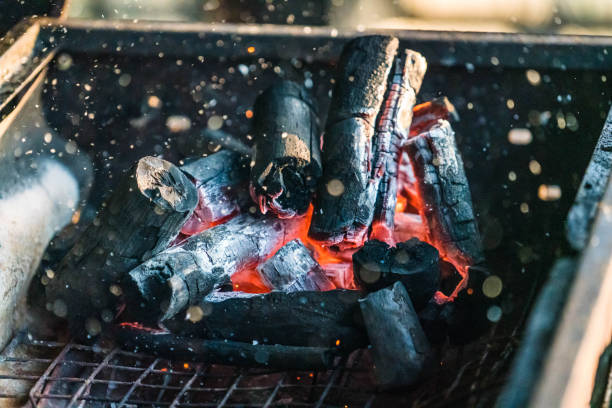 istock Flame and fire spark with bokeh from burning charcoal on a grill 1406881815