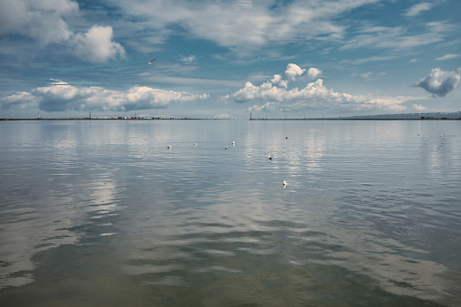 View of a large expanse of water with beautiful clouds in the sky