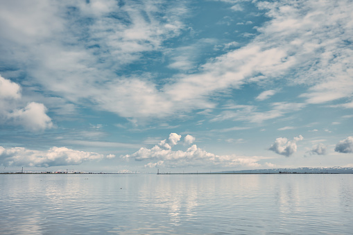 View of a large expanse of water with beautiful clouds in the sky