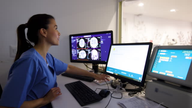 Latin American female radiologist performing an MRI scan at the hospital
