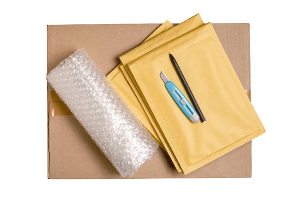 istock Cardboard box, smartphone, bubble pack and packaging tools. The concept of packaging parcels for an online store. View from above. Isolated on a white background. 1406883596