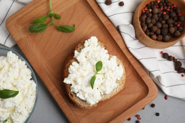 istock Bread with cottage cheese and basil on grey table, flat lay 1406883712