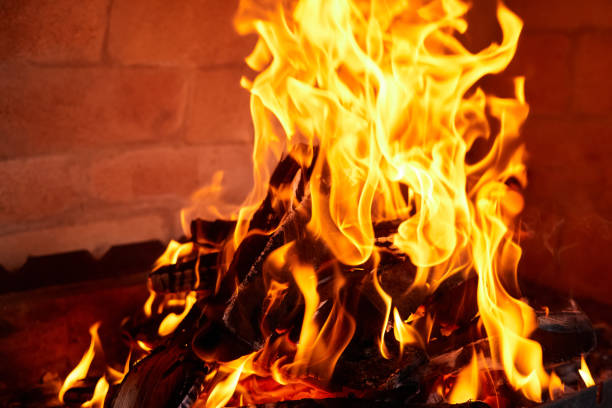 istock Orange flame from burning firewood in a brick grill. Close-up, selective focus 1406883911