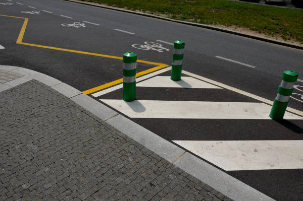 istock road signs drawn on the road side. zebra where he must not stop and park. asphalt with  support of green plastic posts. These posts are made of flexible rubber so they can beat,, paving. marble mosaic 1406885040