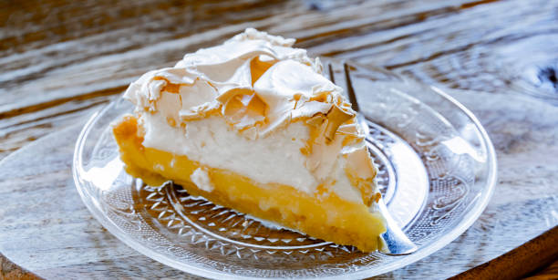 A plate with a lemon meringue tart A plate with a lemon meringue tart. meringue stock pictures, royalty-free photos & images