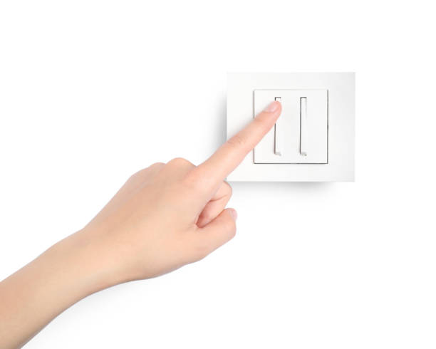 istock Woman pressing light switch on white background, closeup 1406887402