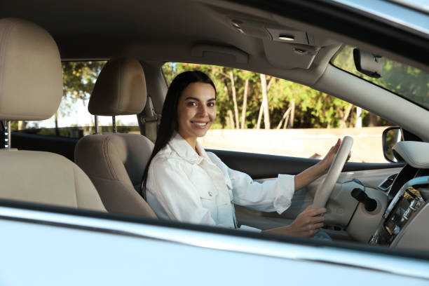 istock Beautiful young driver sitting in modern car 1406887446