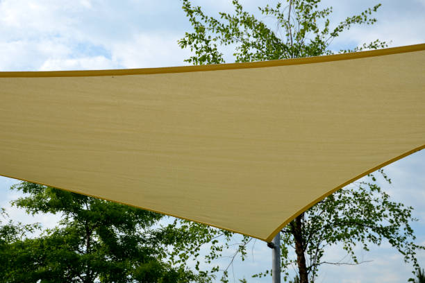 istock white canvas stretched, shading from sun and rain over terrace ofrestaurant, on playground in kindergarten, on platform of the promenade. pergola with metallic gray beams , cable, electric, bulb, led 1406888943