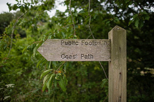 Close up of a wooden sign post pointing to a public path in the North East of England.