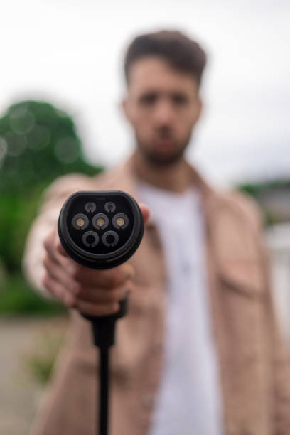 istock Holding up a Car Charger 1406889754