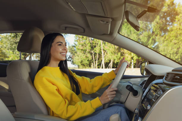 istock Beautiful young driver sitting in modern car 1406889807