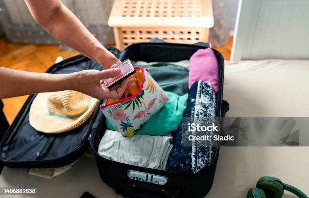 Packing Suitcase For Travel Stock Photo - Download Image Now - Make-Up Bag, Journey, Packing