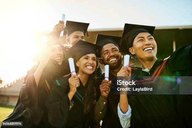 Qualified Students On Graduation Day Group Of Pupils In Gowns Taking A Selfie With Phone At Ceremony Motivated Graduates Capturing Memorable Photos Celebrating Academic Achievement And Milestone Stock Photo - Download Image Now