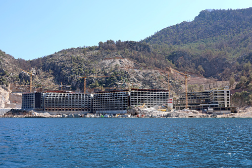 View to mountain bay from water surface, development of summer resort in Turkey