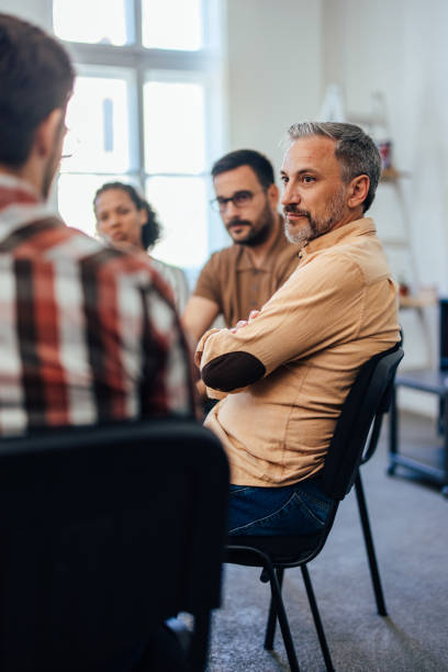 istock A focused man attends group therapy, being calm and listening to others. 1406891874