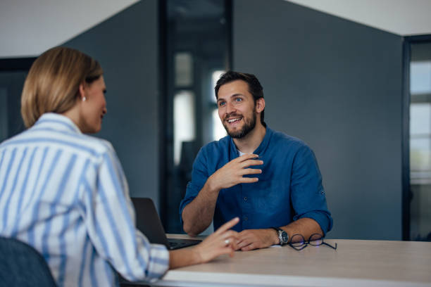 istock Smiling male boss explaining everything about the new job, talking to each other. 1406892450