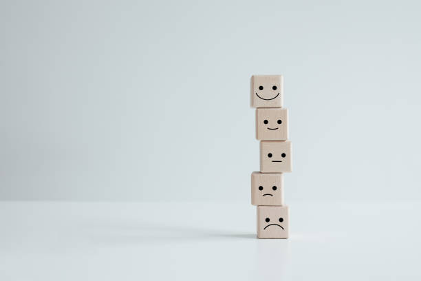 istock Customer service rating experience and feedback emotion and satisfaction survey concept. wood cube with smile, normal and sad face. Negative, neutral and positive facial expressions. 1406892680
