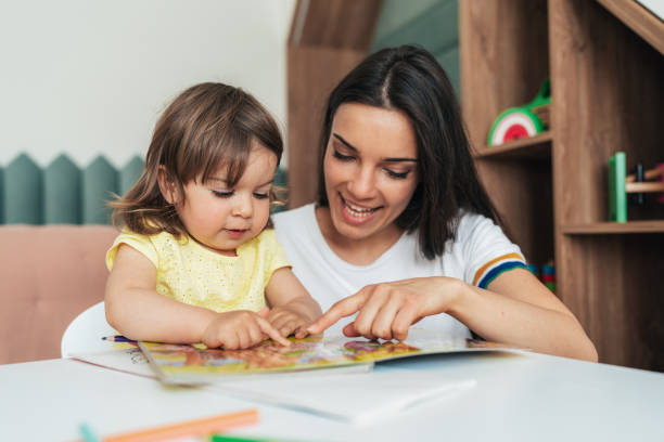 istock Mother and daughter reading book 1406893151