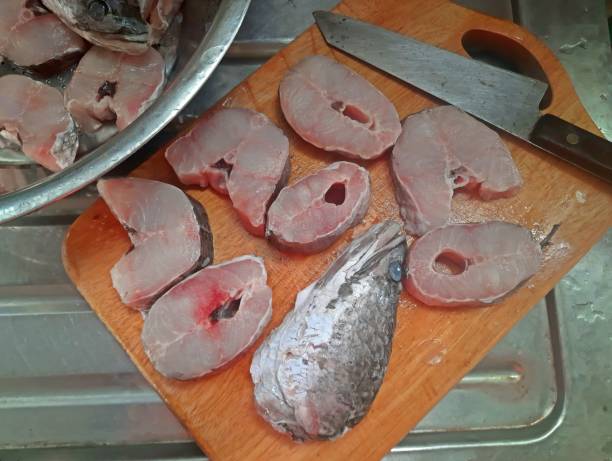 istock Cutting and slicing Snake head fish - food preparation. 1406893270