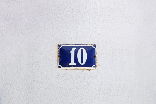 number ten in metallic plate format, with copy space and blue and white color - 10