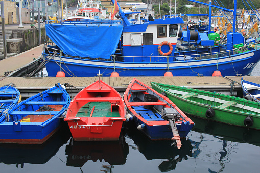 small boats of different colors