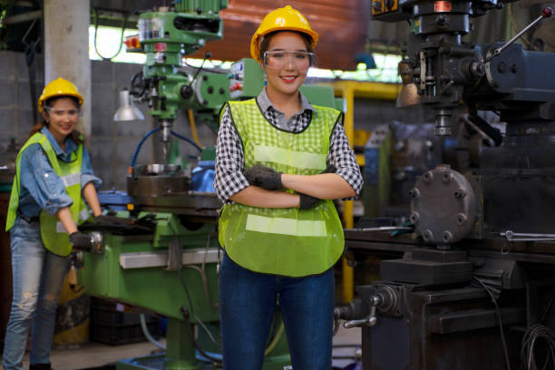istock Blue collar worker with co worker at factory. 1406894836