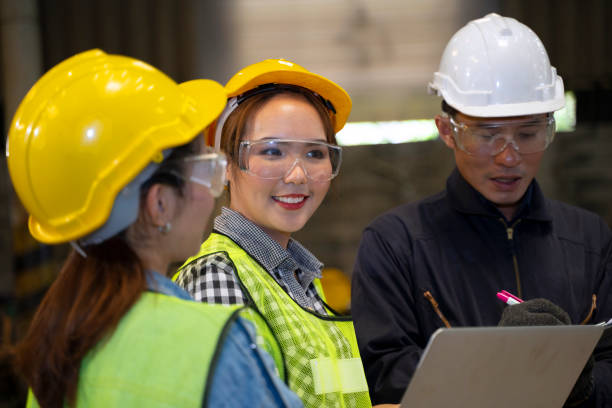 istock Blue collar worker with co worker at factory. 1406894843