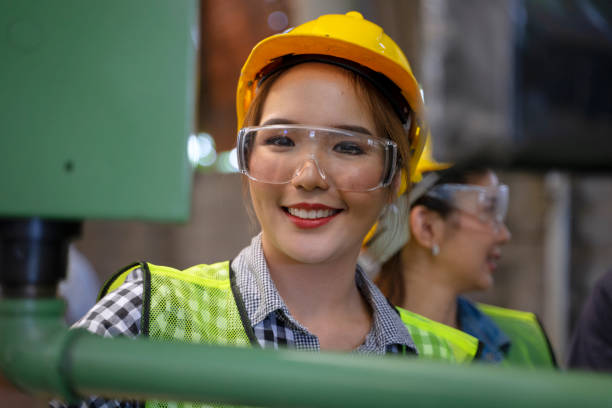 istock Blue collar worker with co worker at factory. 1406894905