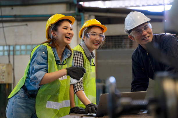istock Blue collar worker with co worker at factory. 1406894930