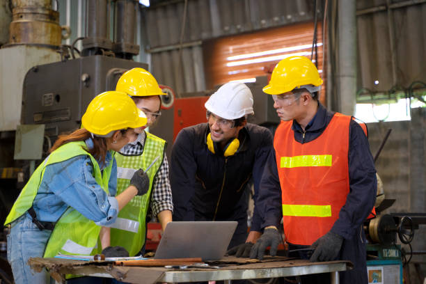 istock Blue collar worker with co worker at factory. 1406894962