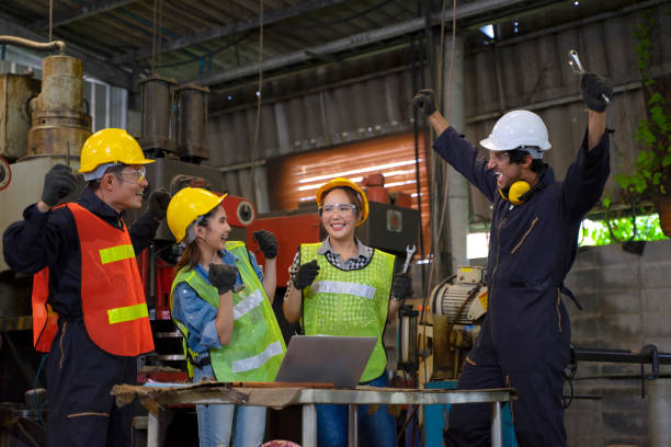 istock Blue collar worker with co worker at factory. 1406895769