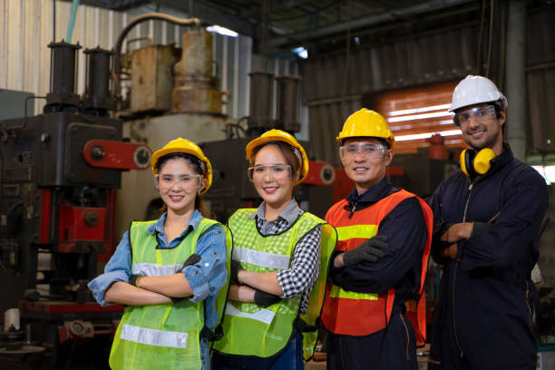 istock Blue collar worker with co worker at factory. 1406895798