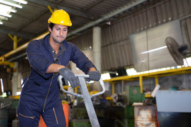 Blue collar worker works machine at factory. Blue collar worker concept.